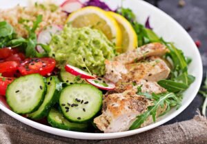 healthy lunch ideas dinner bowl grilled chicken quinoa tomato guacamole red cabbage cucumber arugula